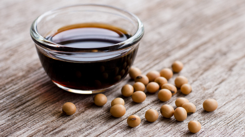 Soy sauce bowl with soybeans beside it