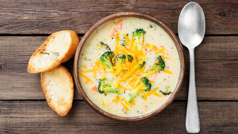 Bowl of broccoli cheddar soup on wood