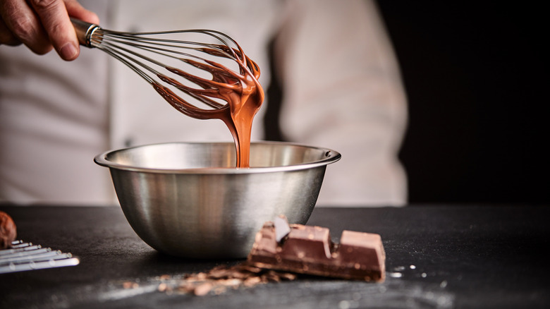 Whisked chocolate in a stainless steel bowl