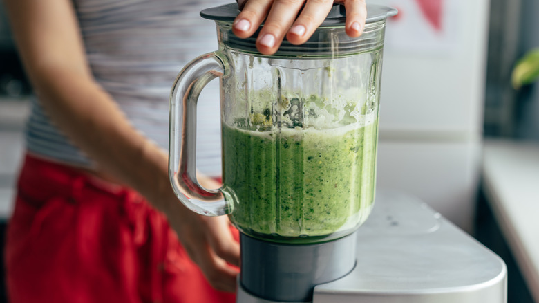 blending a green smoothie