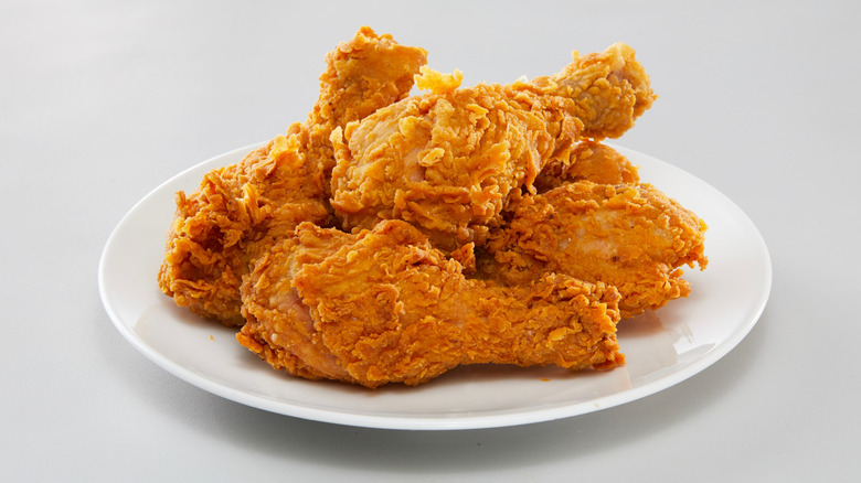 A plate of fried chicken against a white background