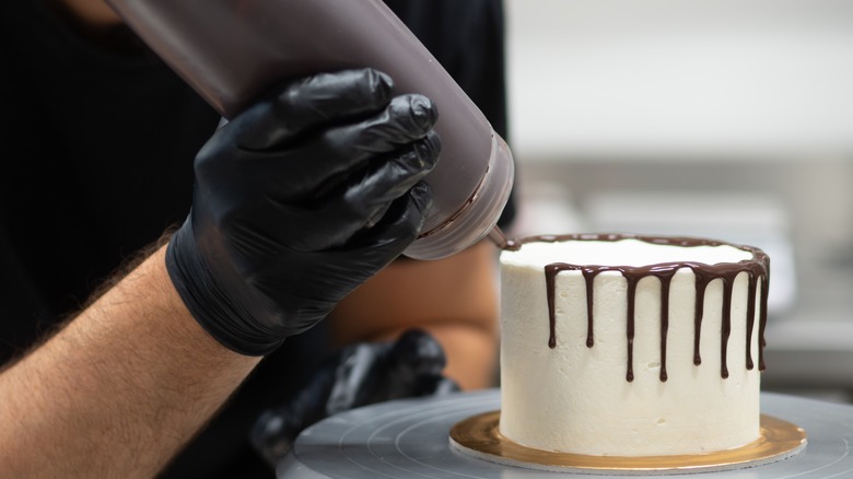 Chocolate drizzled onto cake