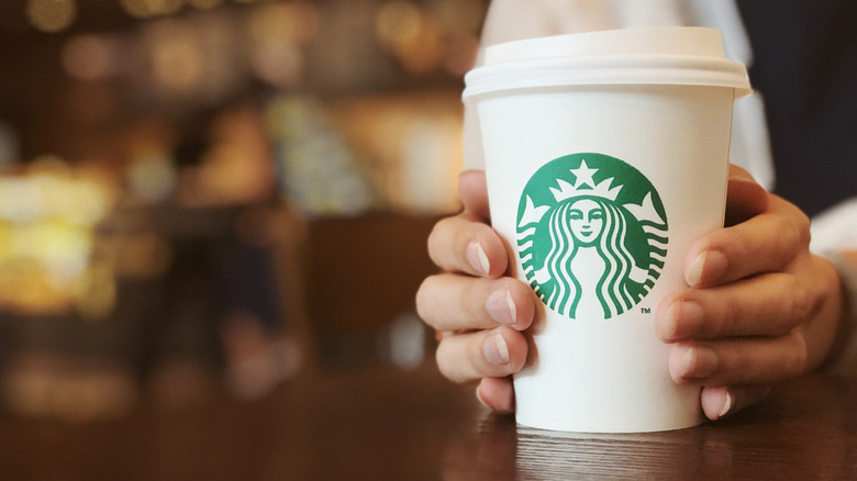 Person holding a Starbucks cup