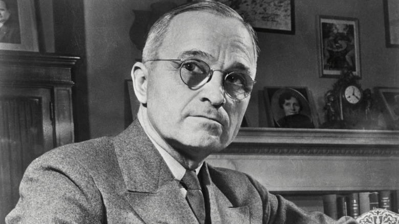 Harry S. Truman in a house gazing into the distance