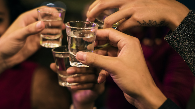 People cheersing with shots