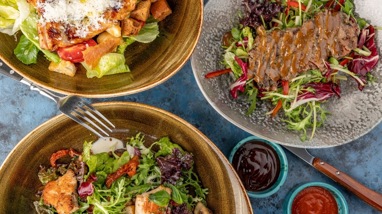three types of salads in bowls