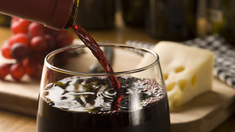 red wine pouring into glass