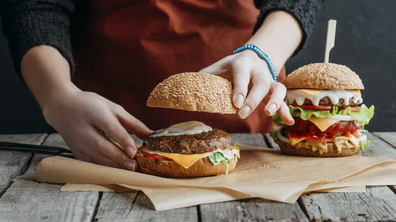 Person assembling a burger