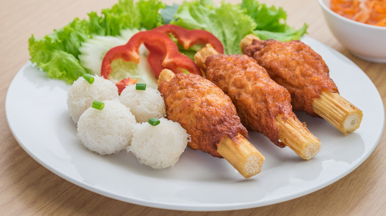 Grilled meat on sugarcane skewers