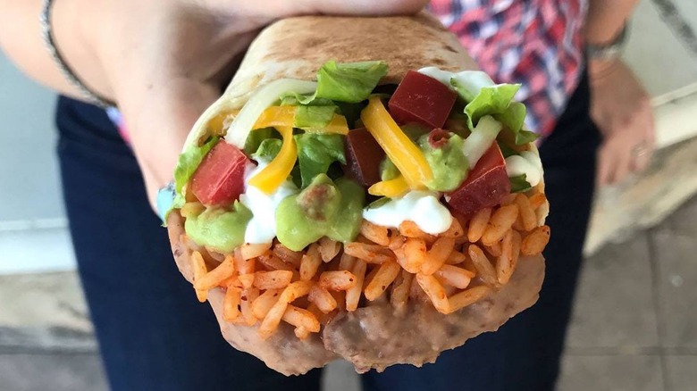 Person holding 7-Layer Burrito