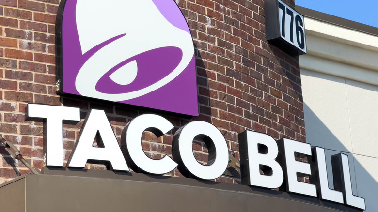 A Taco Bell exterior with white lettering plus the purple and white bell logo