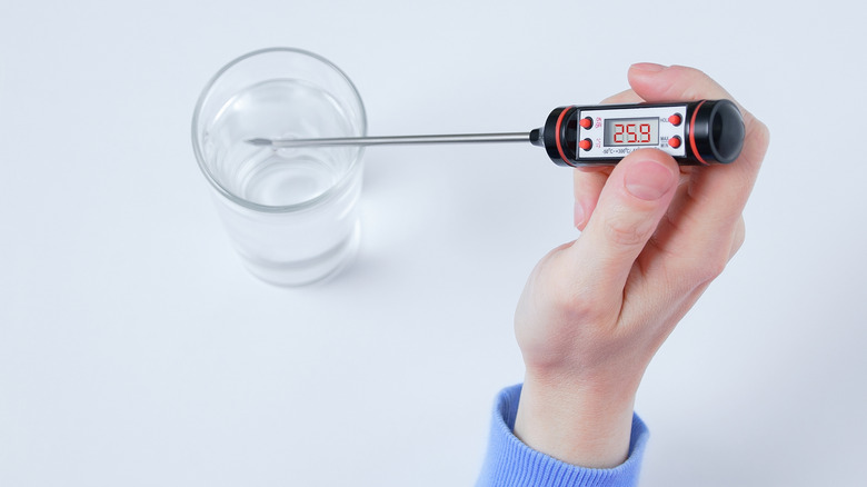 Person checking water temperature