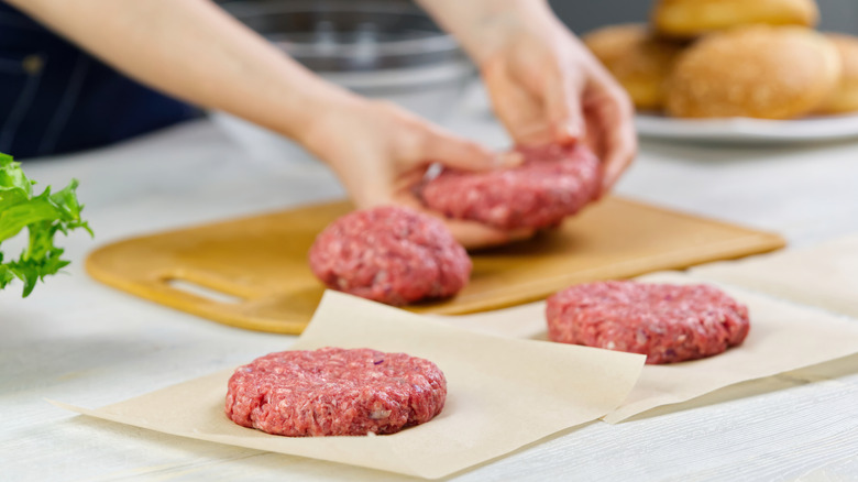 hands shaping burger patties