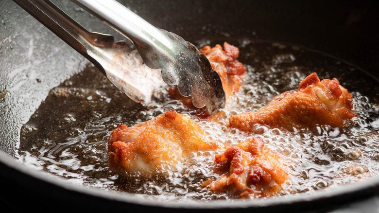 chicken being fried in oil