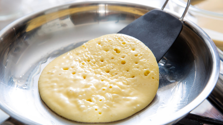 Spatula under pancake to flip
