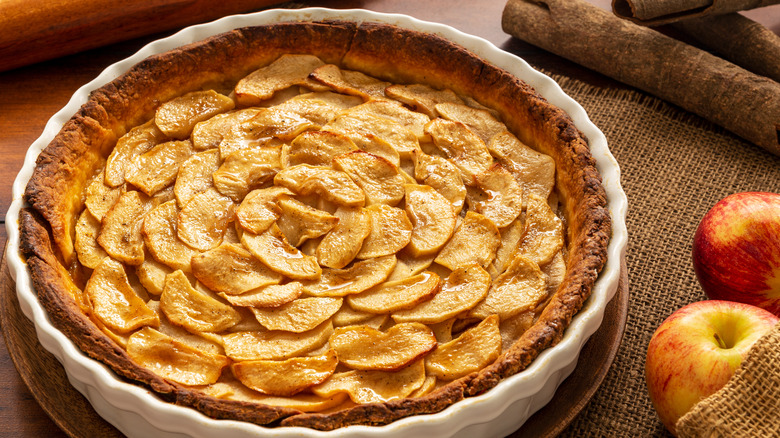 A French apple tart in a white pie holder