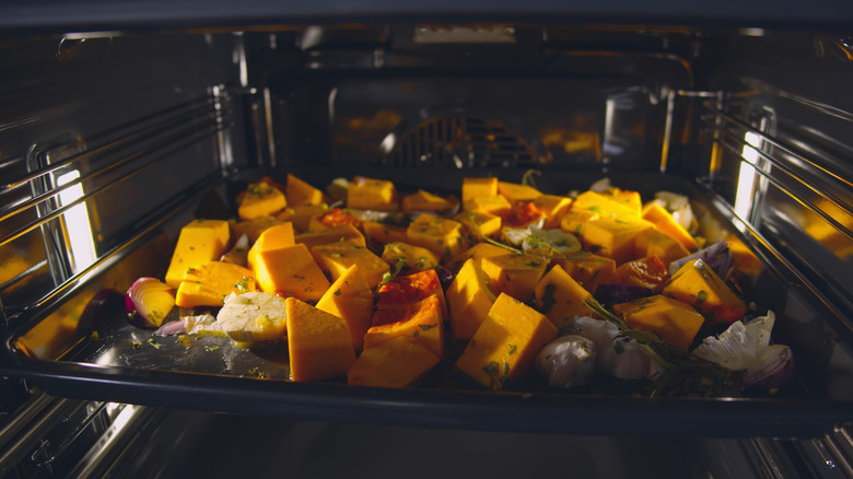pumpkin on baking sheet in oven