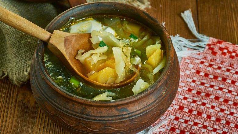 Wooden spoon ladling rustic soup