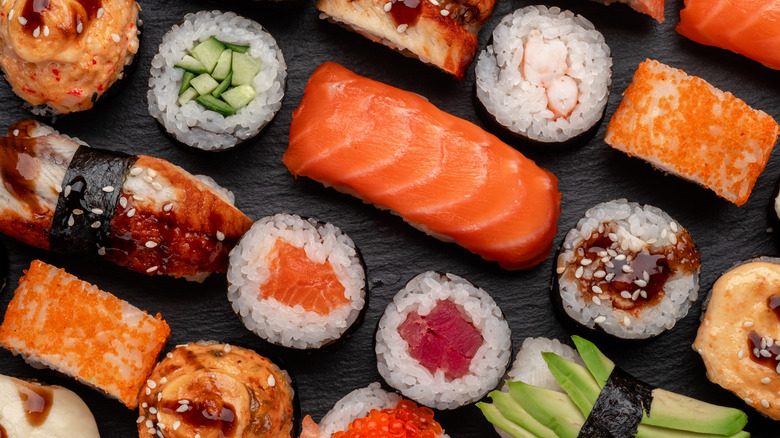 assorted sushi on black table