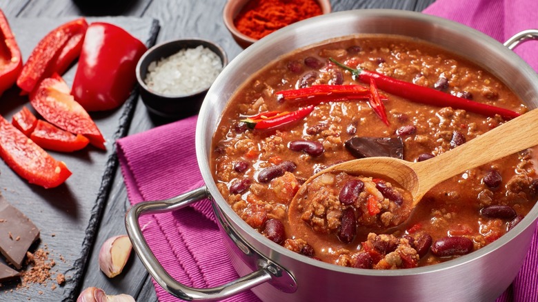 Silber pot with chili and wooden spoon
