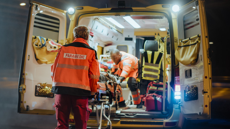 EMT behind ambulance
