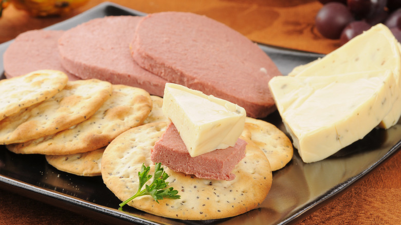 plate of sliced braunschweiger cheese and crackers
