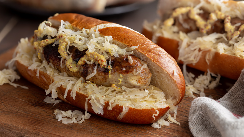 bratwurst on a bun with mustard and sauerkraut
