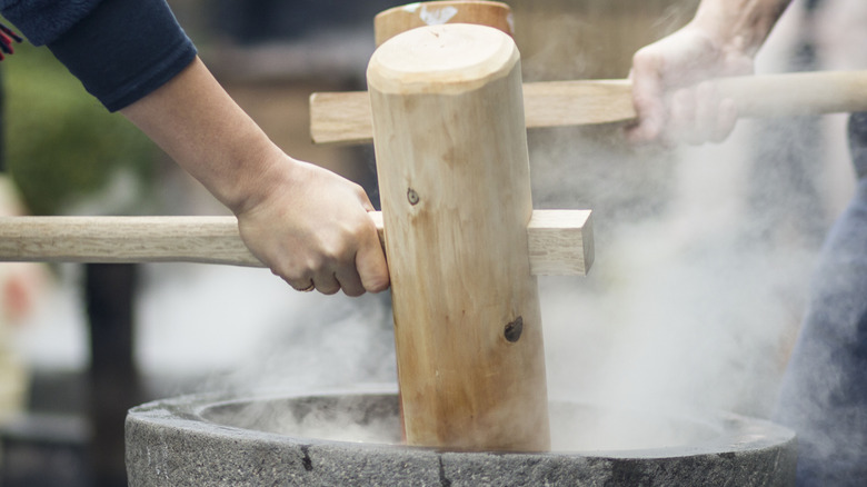 making mochi with hammer