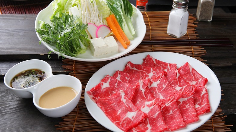raw meats and vegetables plated