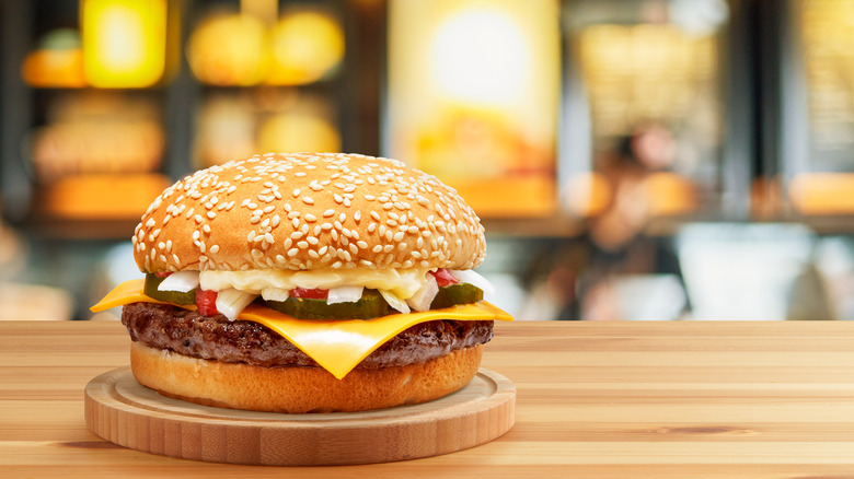A cheeseburger sitting on table