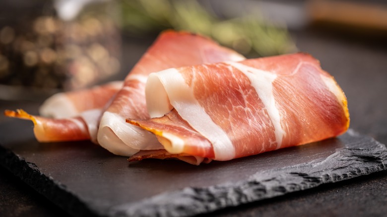 Sliced prosciutto on platter