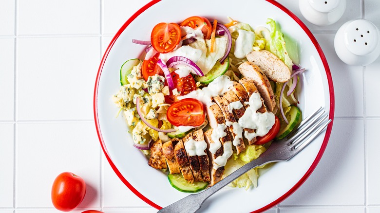 Ranch dressing drizzled on salad