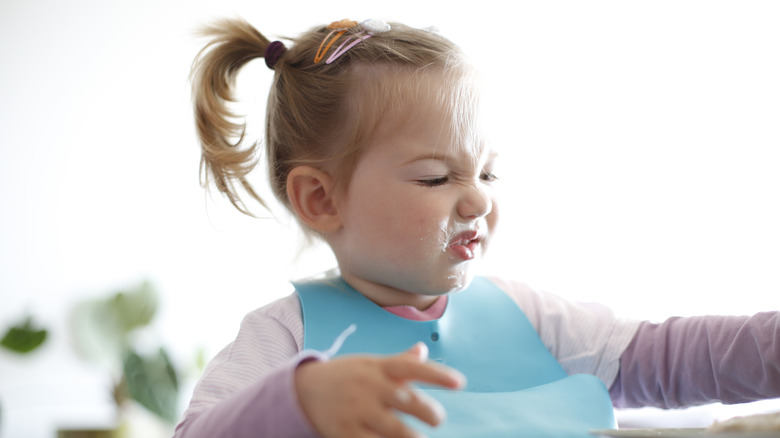 Toddler making disgusted face
