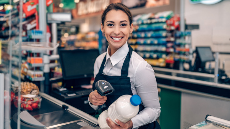 grocery store cashier scanning bottle