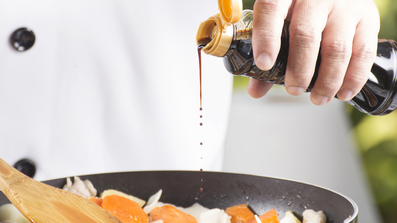 Shoyu being poured into a frying pan