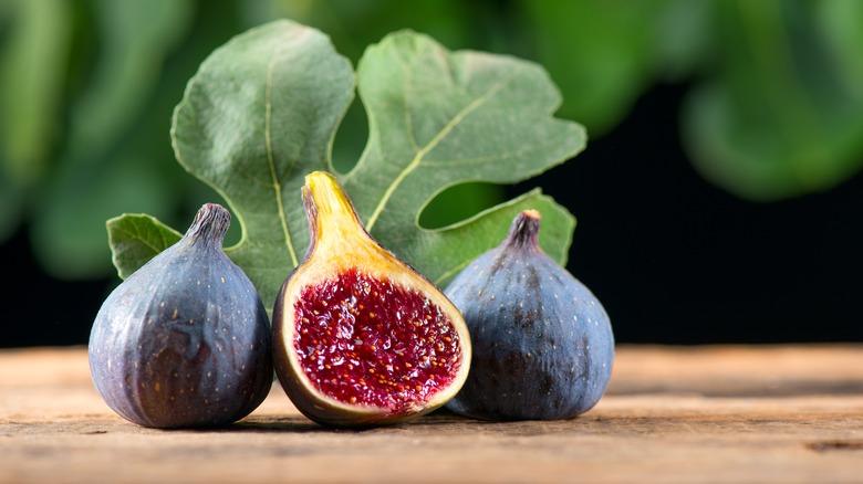 Three figs on wooden table