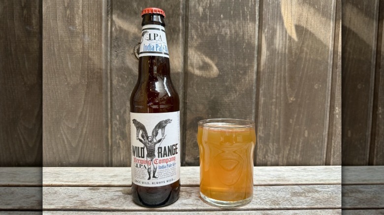A bottle of Wild Range IPA next to a glass of the beer