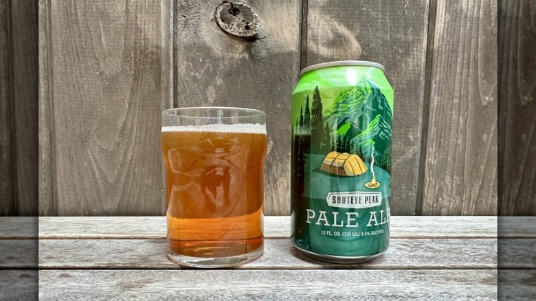 A can of Shuteye Peak Pale Ale next to a glass of the beer