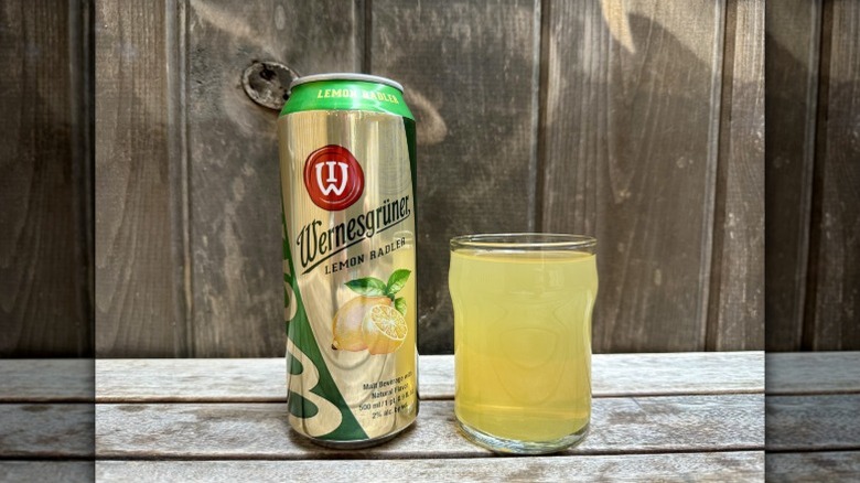 A can of Wernesgruner Lemon Radler next to a glass of the yellow beverage