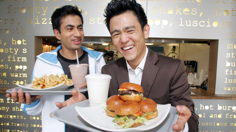 Kal Penn and John Cho holding White Castle food