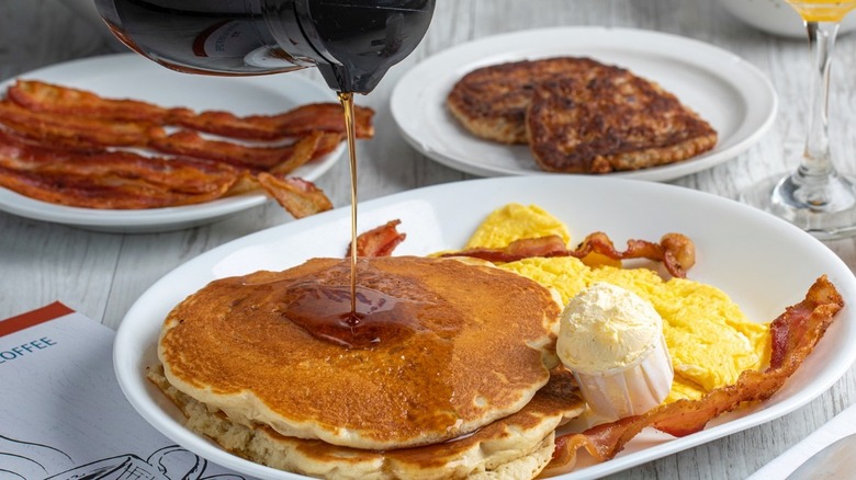 pouring syrup on pancakes