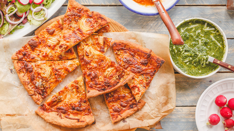 Pizza and bowl of pesto