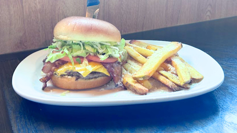 Red Robin's Bacon Cheeseburger and fries on a white platter