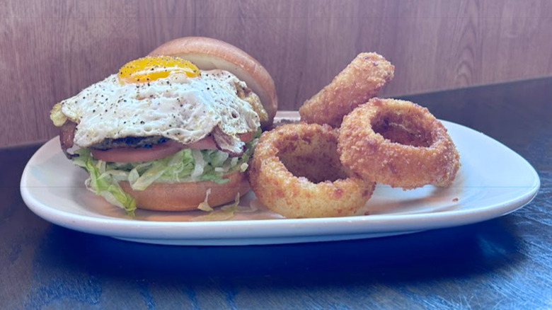 The Royal Red Robin burger and onion rings on a white platter