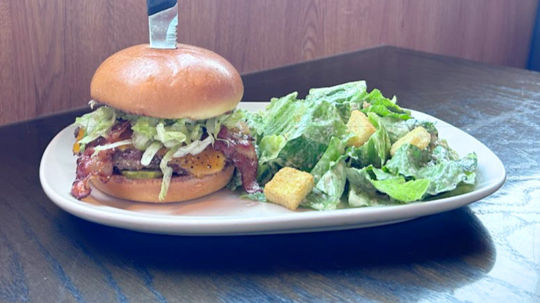 Red Robin's Smoke and Pepper Burger with a salad on a white plate