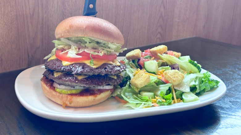 Red Robin's Monster Double and a salad on a white plate
