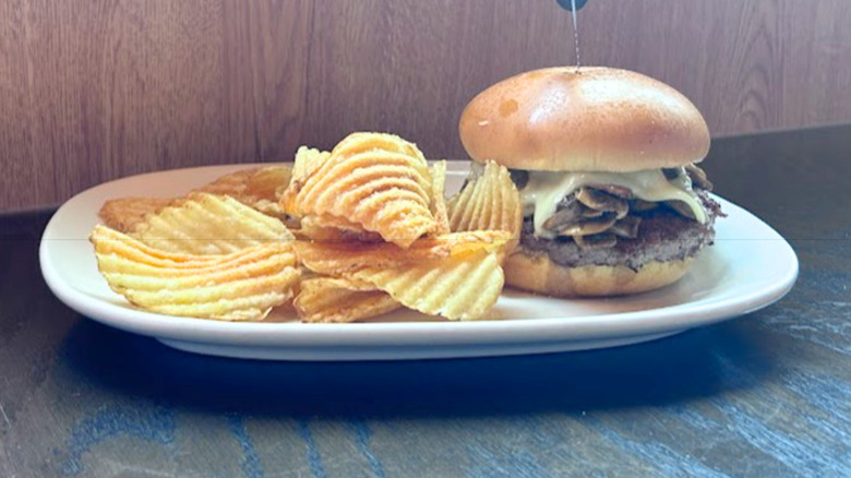 Red Robin's Sautéed Shroom Burger and chips on a white plate