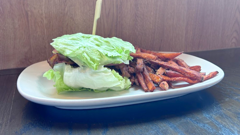 Red Robin's Wedgie Burger and sweet potato fries on a white plate