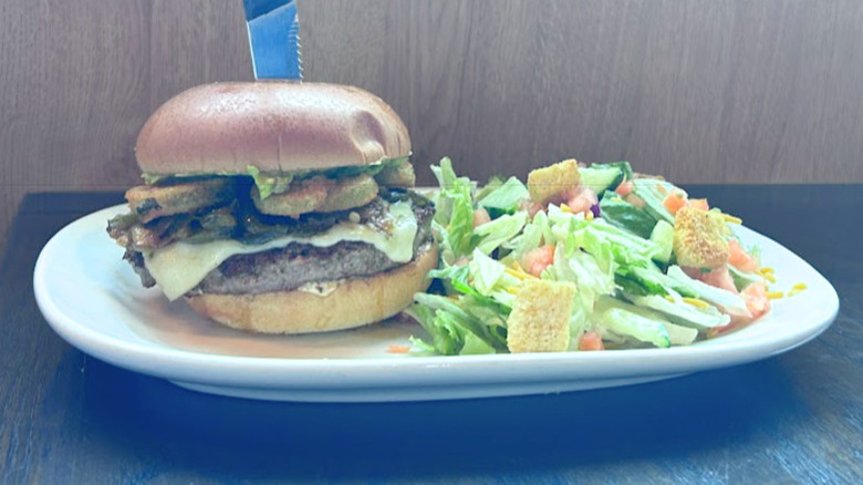 Red Robin's Jalapeño Heatwave Burger and a salad on a white plate