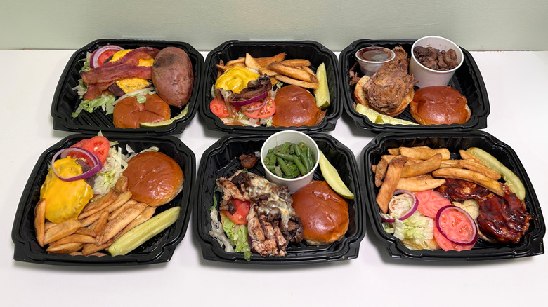 Six containers of Texas Roadhouse burgers and sandwiches against a white and green background